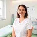 Physiotherapeutin Elektra Arsu in einem hellen Behandlungsraum einer Praxis in Fribourg