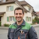 Malermeister Moon Königshofer vor einem renovierten Wohnhaus in Fribourg